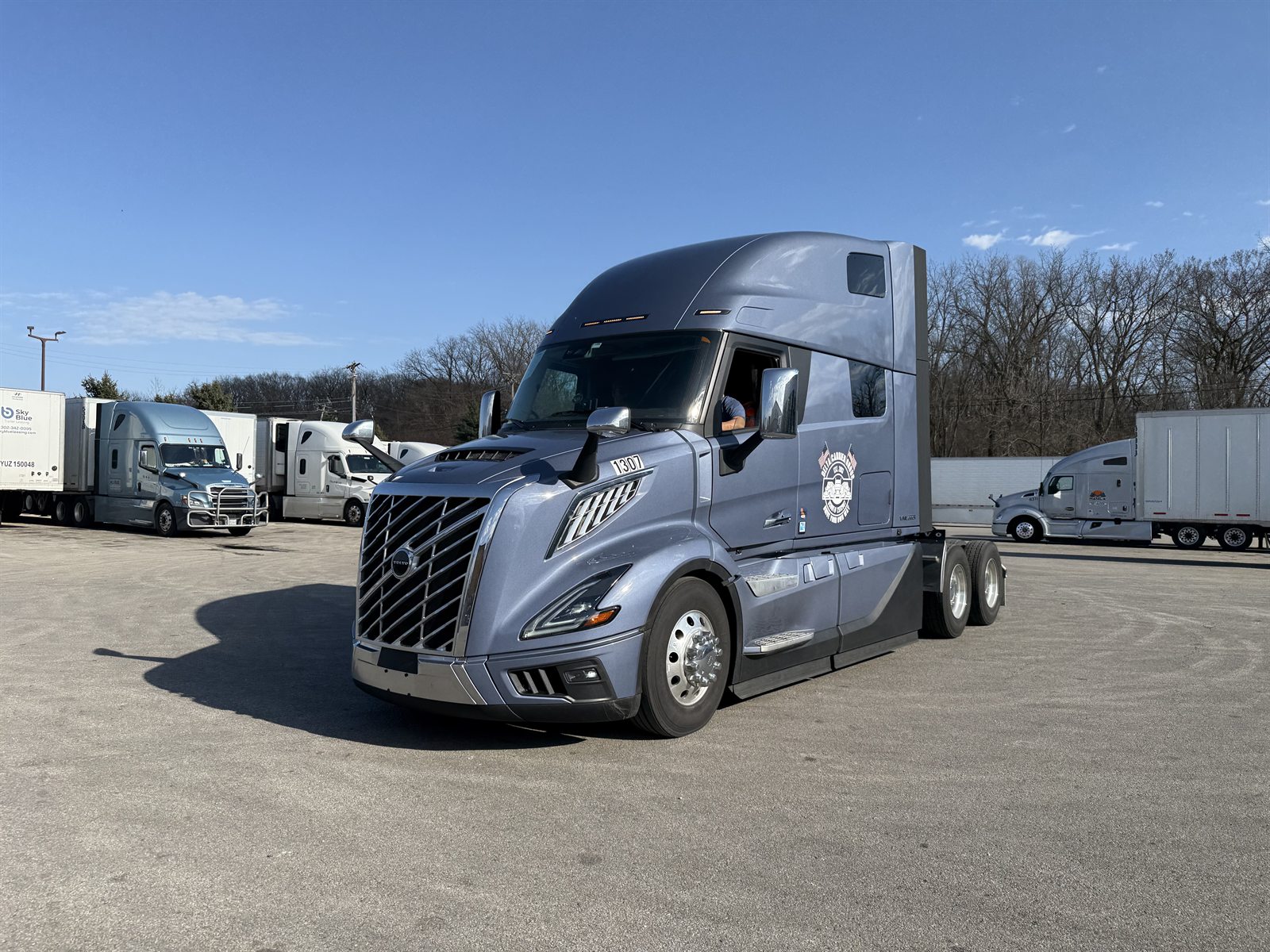 Volvo VNL sleeper with Delta Carrier Group decal under blue sky, unit 1307