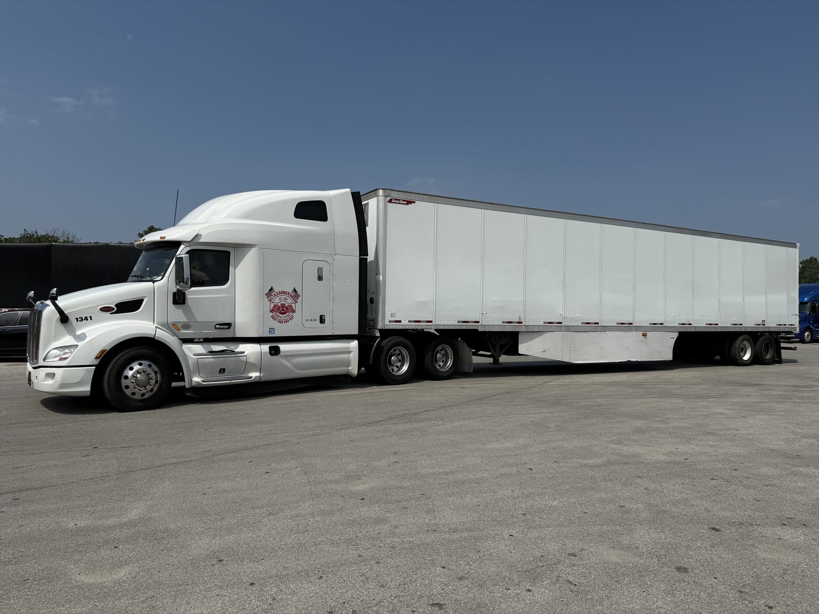 White Peterbilt 579 with Delta badge pulling a dry van trailer, unit 1341